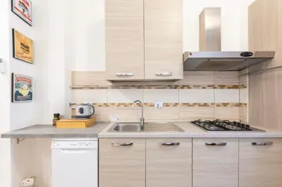a kitchen with a sink and a stove at Luciano Colosseo Apartment in Rome