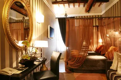 a bedroom with a bed and a mirror at The Inn at the Spanish Steps Prestige Collection - MDR Penthouse in Rome