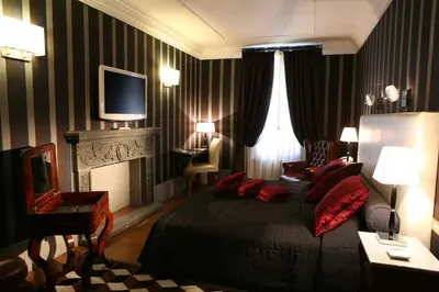 a bedroom with a bed and a fireplace and a television at The Inn at the Spanish Steps Prestige Collection - MDR Penthouse in Rome