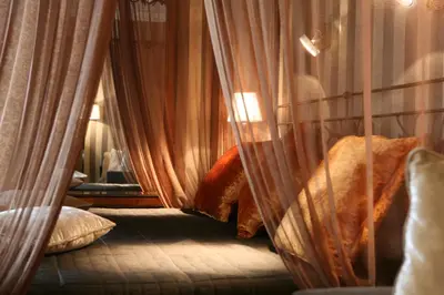 a room with a bed and a mirror and curtains at The Inn at the Spanish Steps Prestige Collection - MDR Penthouse in Rome