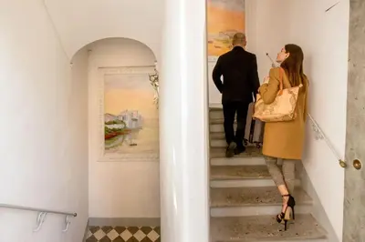a man and a woman walking up the stairs of a museum at The Inn at the Spanish Steps Prestige Collection - MDR Penthouse in Rome