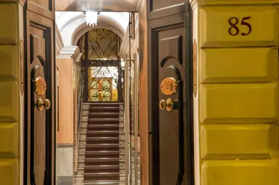 a hallway with a door and stairs in a building at The Inn at the Spanish Steps Prestige Collection - MDR Penthouse in Rome