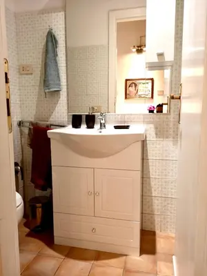a bathroom with a white sink and a mirror at 2B Domus Vaticana 