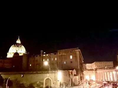 a city at night with a building and a dome at 2B Domus Vaticana 
