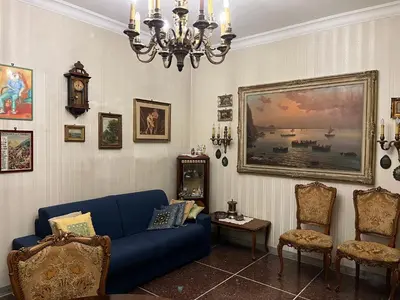 a living room with a blue couch and a chandelier at Domus Amra in Rome