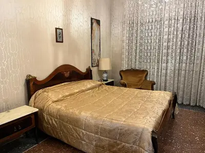 a bedroom with a bed and a table and a chair at Domus Amra in Rome