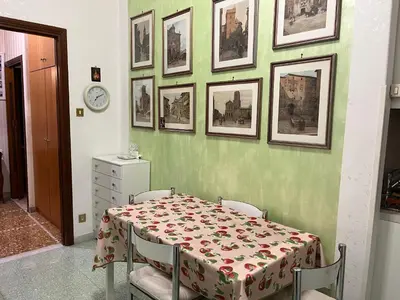 a dining room with a table and pictures on the wall at Domus Amra in Rome
