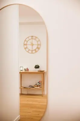 a mirror in a room with a clock on the wall at A Casa di Emy in Rome