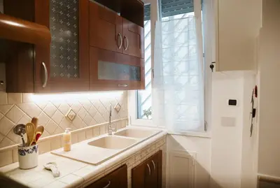 a kitchen with a sink and a window at A Casa di Emy in Rome