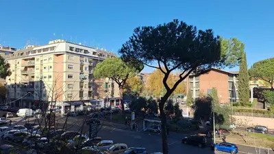 a city street with parked cars and a building at A Casa di Emy in Rome