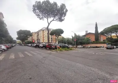 a street with cars parked in a parking lot at A Casa di Emy in Rome