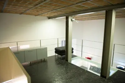 a waiting room with a chair and a mirror at Modern Loft in the center of Rome in Rome