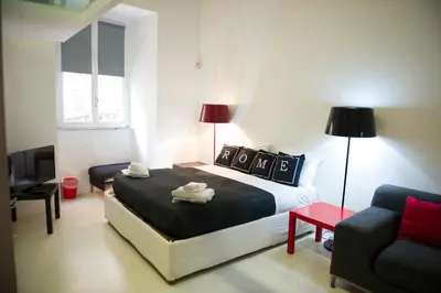 a bedroom with a bed with two towels on it at Modern Loft in the center of Rome in Rome