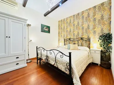 a bedroom with a bed and a wall mural at Via Veneto Lulus Home in Rome