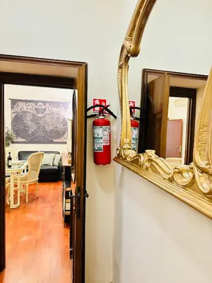 a fire extinguisher is sitting on a shelf next to a mirror at Via Veneto Lulus Home in Rome