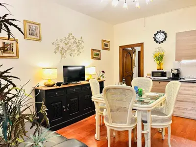 a dining room with a table and chairs at Via Veneto Lulus Home in Rome