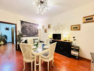 a dining room with a table and chairs at Via Veneto Lulus Home in Rome