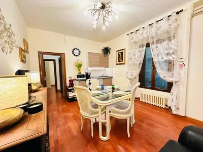 a dining room with a table and chairs at Via Veneto Lulus Home in Rome