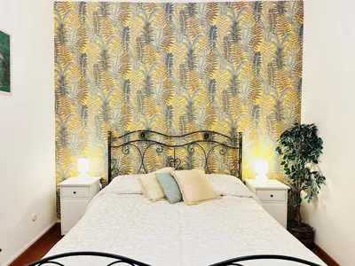 a bedroom with a large bed with a wallpaper at Via Veneto Lulus Home in Rome