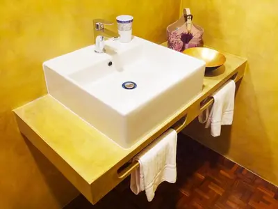 a bathroom with a white sink and towels on a counter at A Star Inn in Rome