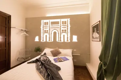 a bedroom with a bed with a poster on the wall at A Star Inn in Rome