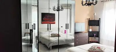 a bedroom with two beds and a mirror at CasAppia in Rome
