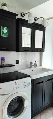 a kitchen with a washing machine and a sink at CasAppia in Rome