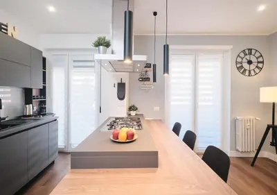 a kitchen with a table with a bowl of fruit on it at COLOSSEO a 15 minuti - Suite Elegante in Centro in Rome