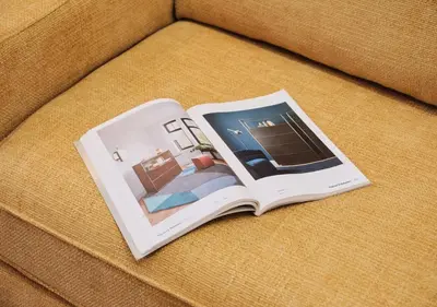 a book sitting on top of a couch at COLOSSEO a 15 minuti - Suite Elegante in Centro in Rome