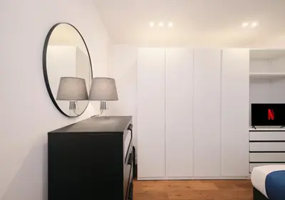 a bedroom with a mirror and a black dresser at COLOSSEO a 15 minuti - Suite Elegante in Centro in Rome