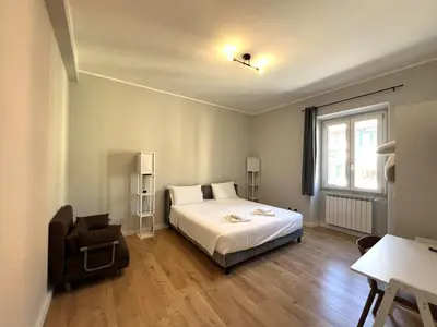 a hallway with a mirror and a dining room at L'affaccio sul borgo - Adiacente Metro B in Rome