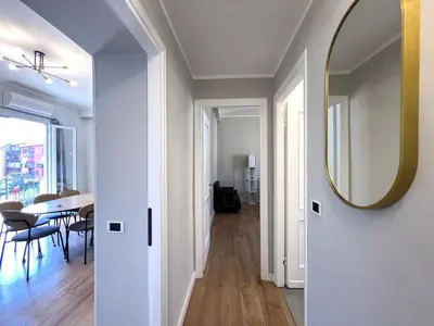 a living room with a dining room table and chairs at L'affaccio sul borgo - Adiacente Metro B in Rome