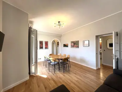 a kitchen and a dining room with a table and chairs at L'affaccio sul borgo - Adiacente Metro B in Rome