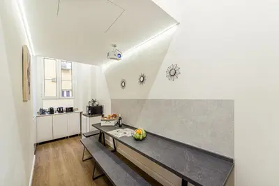 a living room with a bench and a kitchen at Rome Aparts - 3 bedrooms luxury apartment at St Peter in Rome