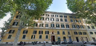 a large yellow building with motorcycles parked in front of it at Rome Aparts - 3 bedrooms luxury apartment at St Peter in Rome