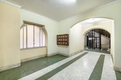 an empty room with a green floor and windows at Rome Aparts - 3 bedrooms luxury apartment at St Peter in Rome