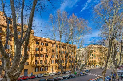 a large building with cars parked in a parking lot at Rome Aparts - 3 bedrooms luxury apartment at St Peter in Rome