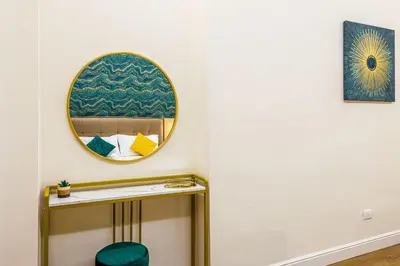 a bathroom with a mirror and a stool at Rome Aparts - 3 bedrooms luxury apartment at St Peter in Rome