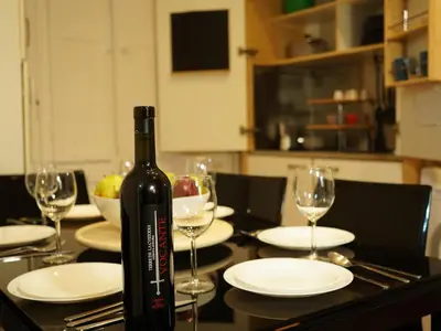a bottle of wine sitting on a table with glasses at Charming Home in Termini in Rome