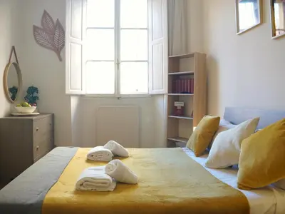 a bedroom with towels on a bed with a window at Charming Home in Termini in Rome