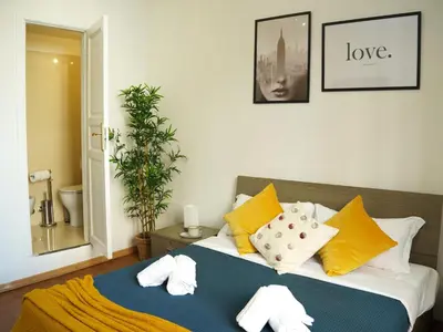 a bedroom with a bed with towels on it at Charming Home in Termini in Rome