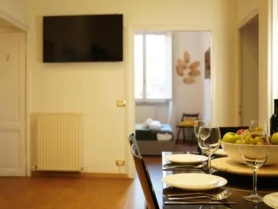 a dining room table with a bowl of fruit and wine glasses at Charming Home in Termini in Rome