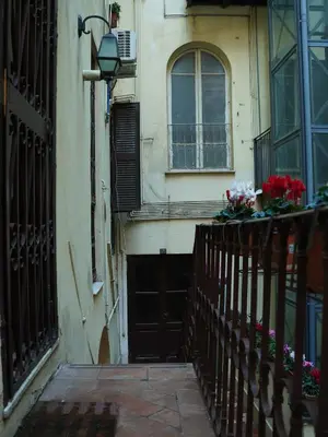 a building with a door and a window and flowers at Charming Home in Termini in Rome