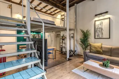 a loft apartment with a loft bed and a living room at Monti View Apartment in Rome