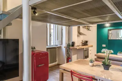 a kitchen and dining room with a red refrigerator at Monti View Apartment in Rome