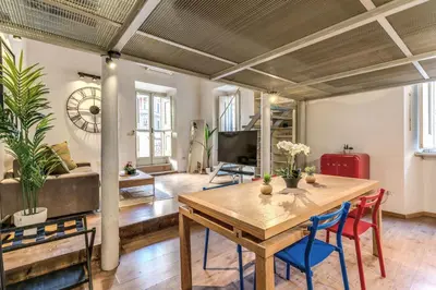 a living room with a wooden table and chairs at Monti View Apartment in Rome