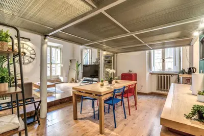 a living room with a wooden table and chairs at Monti View Apartment in Rome