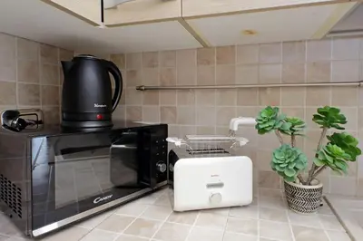 a kitchen with a coffee maker and a microwave at 4BNB - Ripetta Central Apartment in Rome
