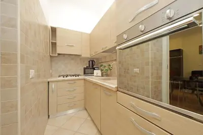 a small kitchen with a sink and a counter at 4BNB - Ripetta Central Apartment in Rome