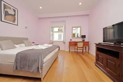 a bedroom with a bed and a flat screen tv at 4BNB - Ripetta Central Apartment in Rome